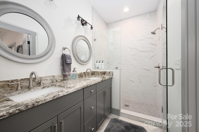 bathroom with vanity and a shower with shower door