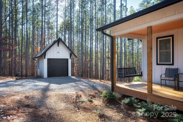 exterior space with a deck, a garage, and an outdoor structure