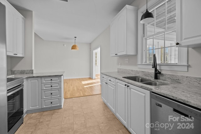 kitchen with white cabinets, dishwasher, stove, and hanging light fixtures