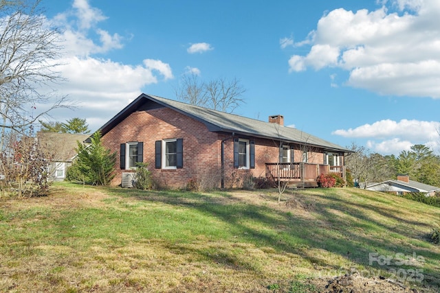 view of home's exterior with a lawn and a wooden deck