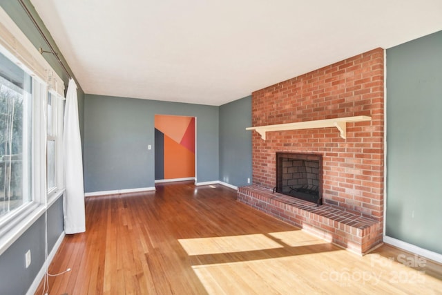 unfurnished living room featuring a fireplace and wood-type flooring