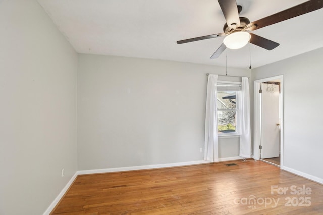 empty room with hardwood / wood-style flooring and ceiling fan