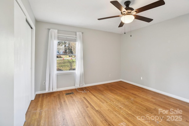 spare room featuring light hardwood / wood-style flooring and ceiling fan