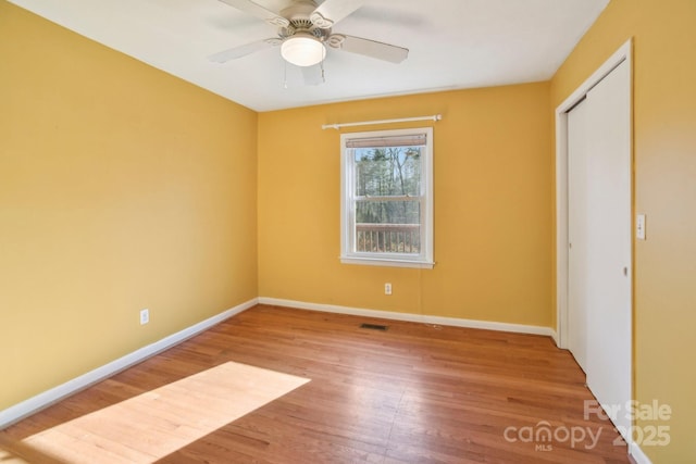 unfurnished room with hardwood / wood-style flooring and ceiling fan