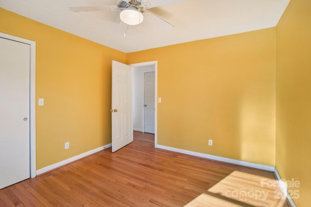 unfurnished bedroom with ceiling fan and hardwood / wood-style flooring