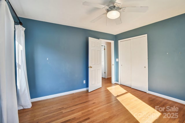 unfurnished bedroom with ceiling fan, light hardwood / wood-style flooring, and a closet