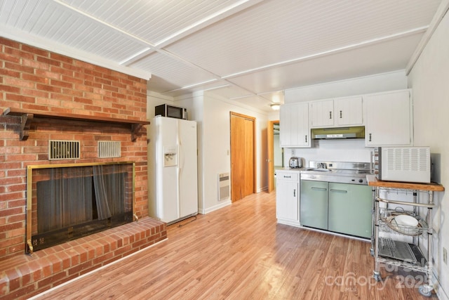 kitchen featuring stainless steel counters, light hardwood / wood-style flooring, white refrigerator with ice dispenser, a fireplace, and white cabinets