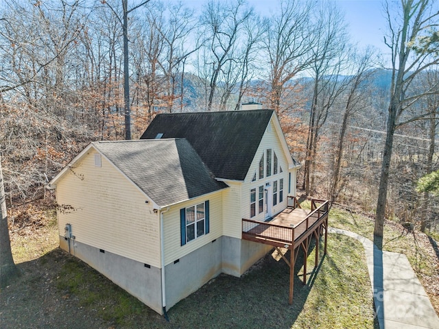 view of side of property with a wooden deck