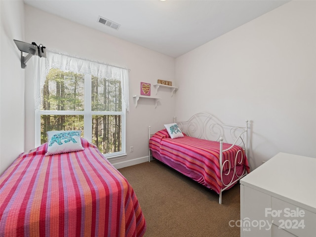 bedroom with dark colored carpet