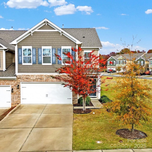 view of front of property featuring a front yard and a garage