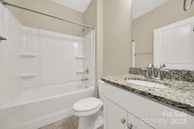 full bathroom featuring toilet, vanity, tile patterned floors, and washtub / shower combination