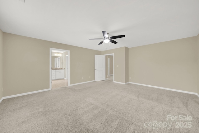 unfurnished bedroom with light carpet, ensuite bathroom, and ceiling fan