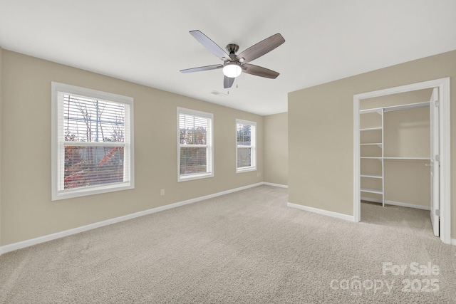 unfurnished bedroom featuring light colored carpet and ceiling fan