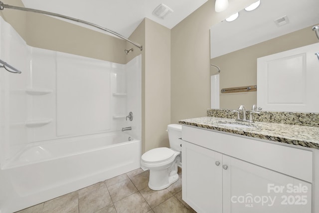 full bathroom featuring washtub / shower combination, tile patterned floors, vanity, and toilet