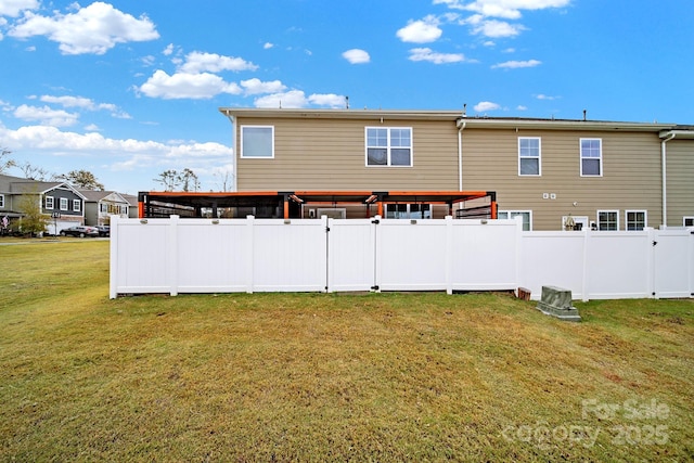 rear view of property with a yard