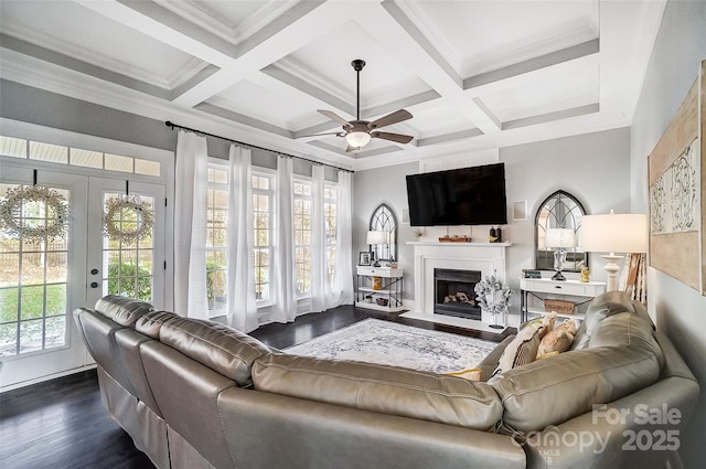 living room with coffered ceiling, dark hardwood / wood-style floors, and beam ceiling