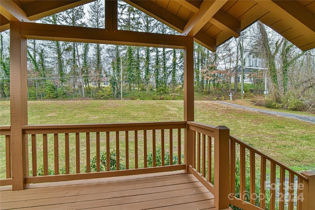 wooden deck with a lawn