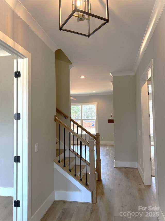 interior space with crown molding, baseboards, wood finished floors, and recessed lighting