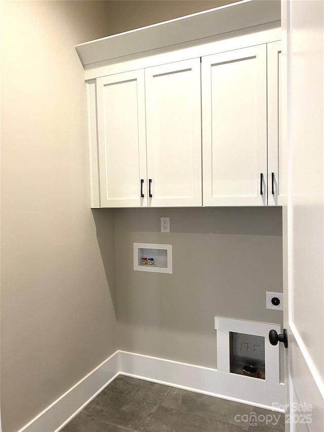 washroom featuring electric dryer hookup, washer hookup, cabinet space, and baseboards