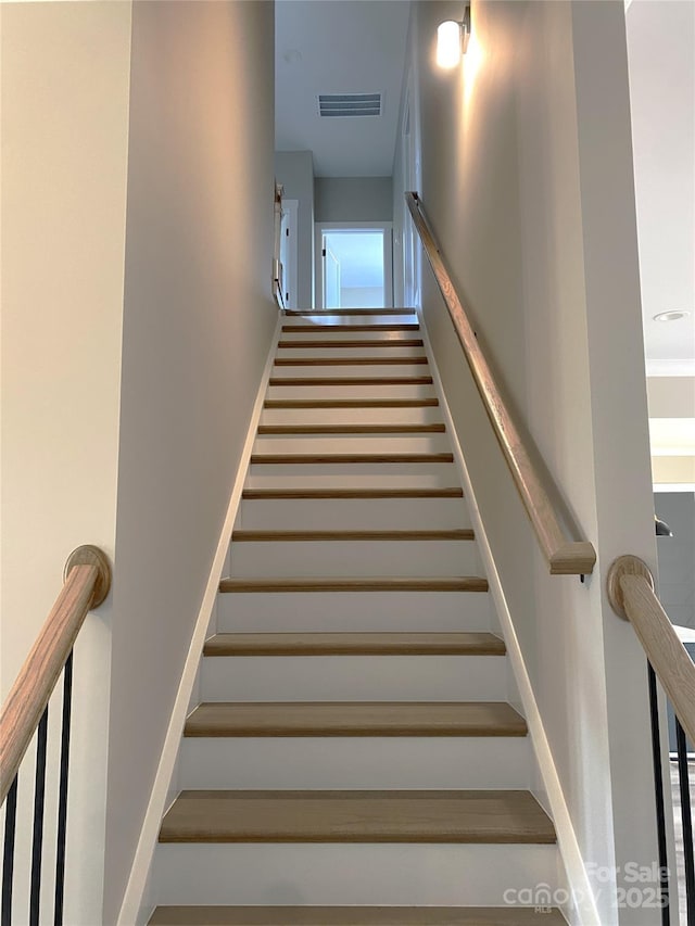 staircase featuring visible vents