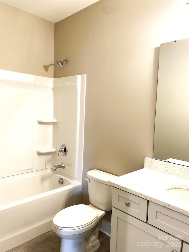 bathroom with toilet, vanity, baseboards,  shower combination, and tile patterned floors