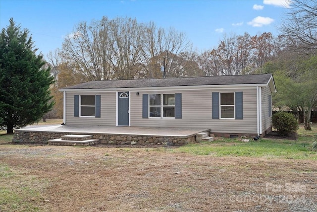 view of front of home with a patio area and a front yard