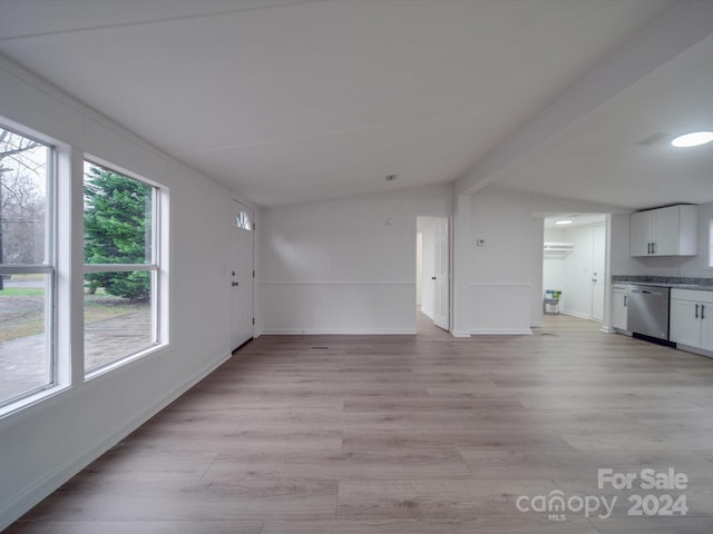 unfurnished living room with light wood-type flooring and vaulted ceiling with beams