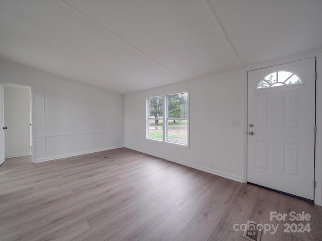 foyer entrance with light wood-type flooring and a wealth of natural light