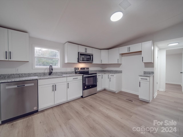 kitchen with white cabinetry, sink, appliances with stainless steel finishes, and light hardwood / wood-style flooring