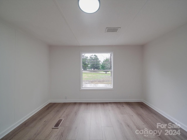 spare room with light hardwood / wood-style flooring