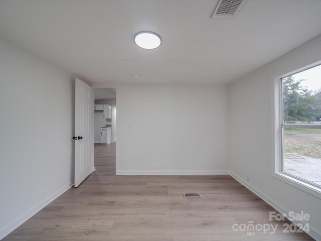 unfurnished room with a wealth of natural light and light hardwood / wood-style floors