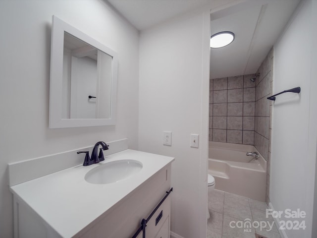 full bathroom featuring tile patterned floors, vanity, toilet, and tiled shower / bath combo