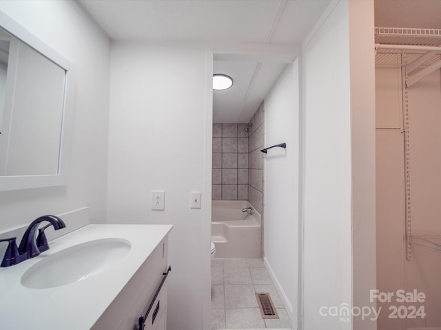 full bathroom featuring tile patterned flooring, vanity, toilet, and tiled shower / bath