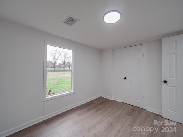 unfurnished room featuring light hardwood / wood-style floors