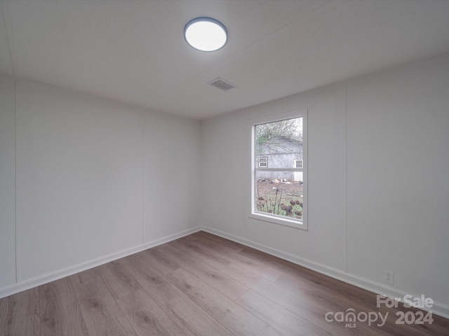 spare room featuring light wood-type flooring