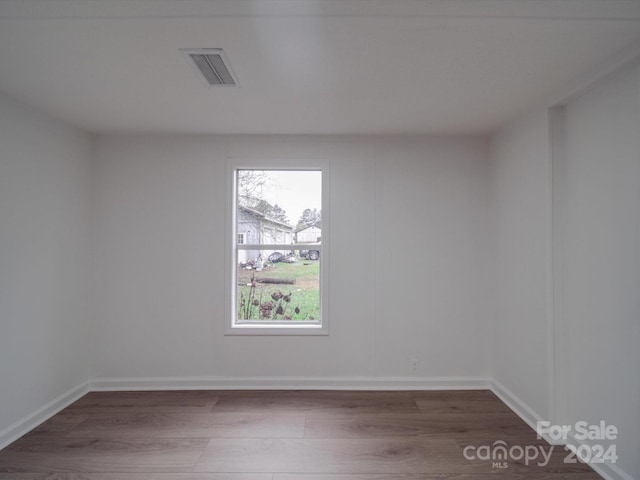 spare room with dark wood-type flooring