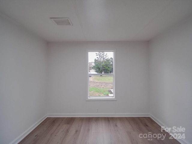 spare room with light hardwood / wood-style flooring