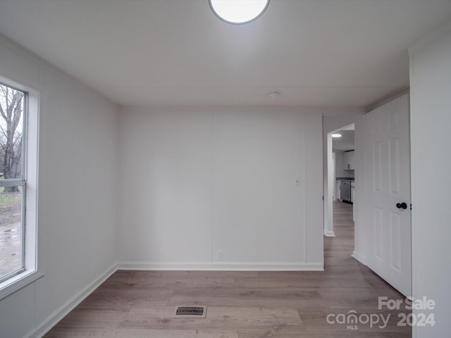 spare room featuring plenty of natural light and light hardwood / wood-style floors