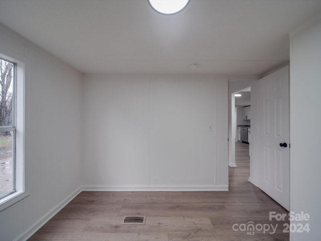 empty room featuring light wood-type flooring and a wealth of natural light