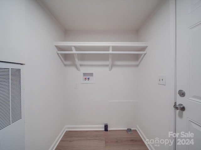 laundry area featuring hardwood / wood-style floors and washer hookup