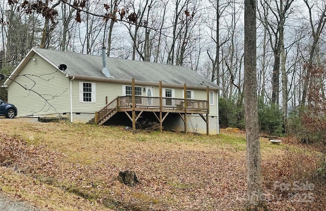 back of property with a wooden deck