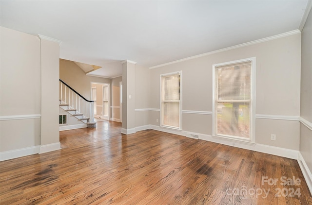 unfurnished room with hardwood / wood-style flooring and crown molding