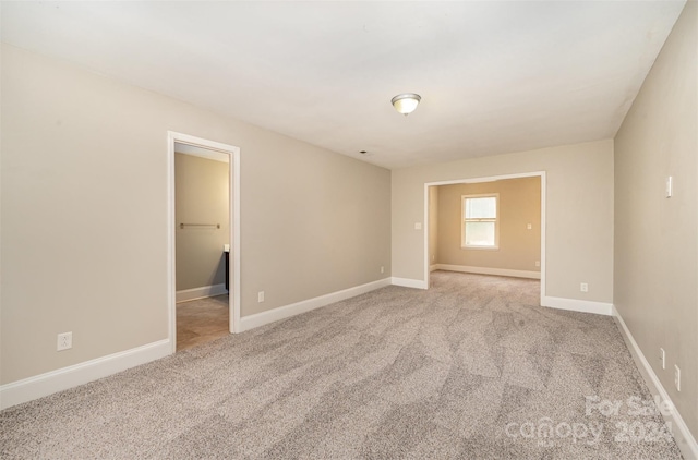 spare room featuring light colored carpet