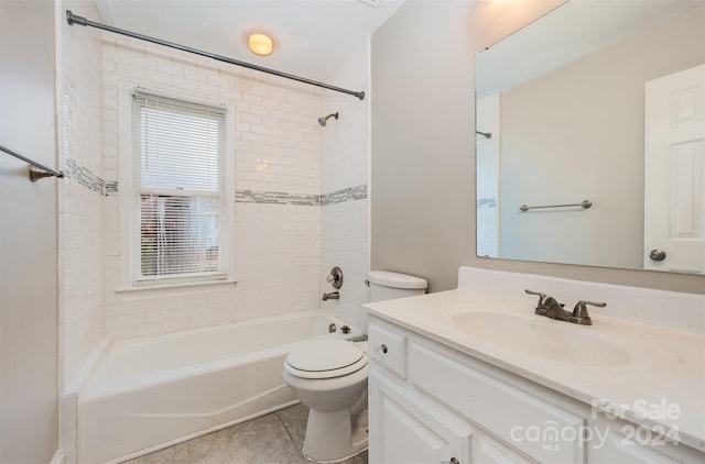 full bathroom featuring tile patterned floors, vanity, toilet, and tiled shower / bath combo