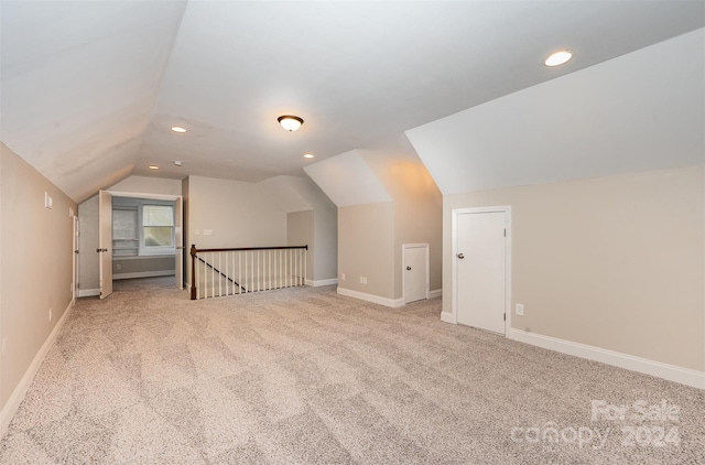 additional living space with light carpet and lofted ceiling