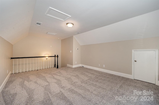 additional living space with carpet floors and vaulted ceiling