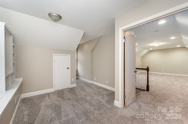 bonus room with lofted ceiling and carpet floors