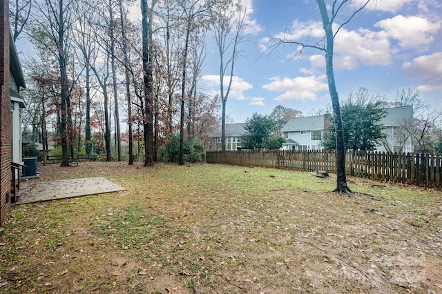 view of yard with central AC and a patio area