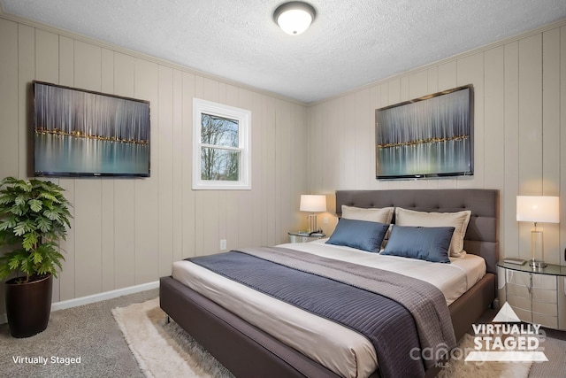 bedroom featuring a textured ceiling and light carpet