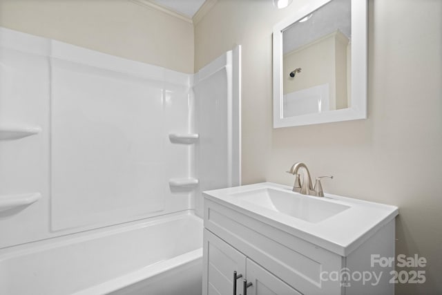 bathroom with shower / washtub combination, vanity, and ornamental molding